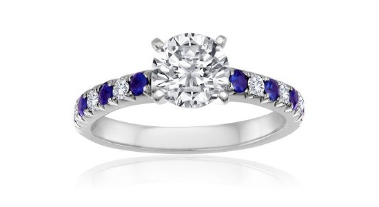 White gold Imagine Bridal engagement ring with a round cut center stone and diamond and sapphire side stones
