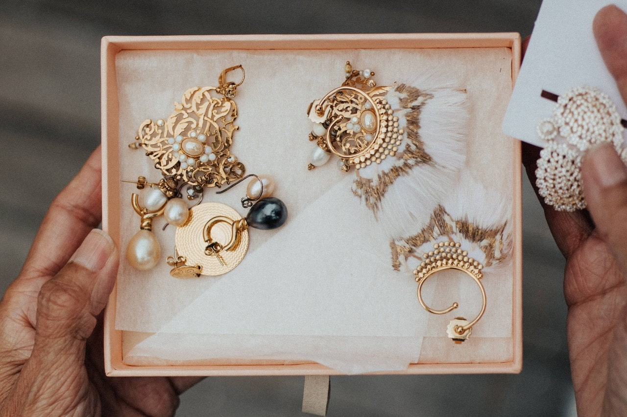 Box full of gold jewelry and pearls