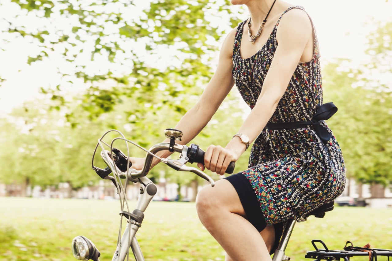 Woman wearing a watch and riding a bicycle
