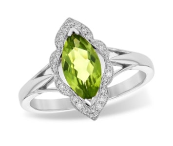 A cocktail peridot ring crafted from 14k white gold