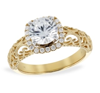 A detailed halo engagement ring from Allison-Kaufman features vintage details and yellow gold