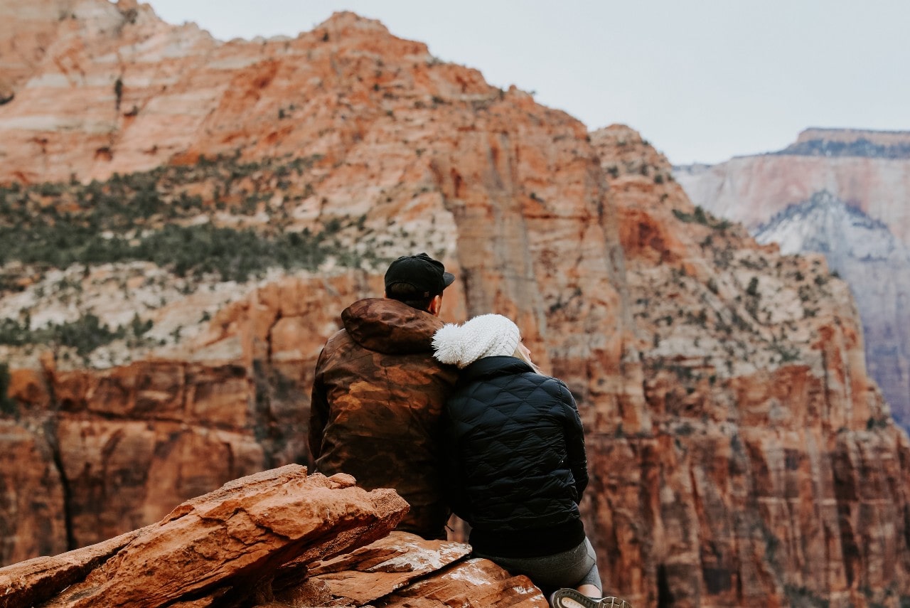 A bundled-up couple takes in a view of a canyon on Valentine’s Day.