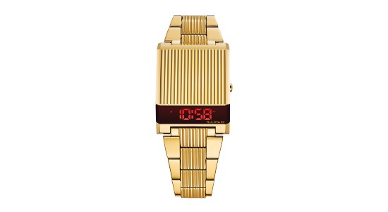 a yellow gold, retro-inspired watch featuring a digital watch face