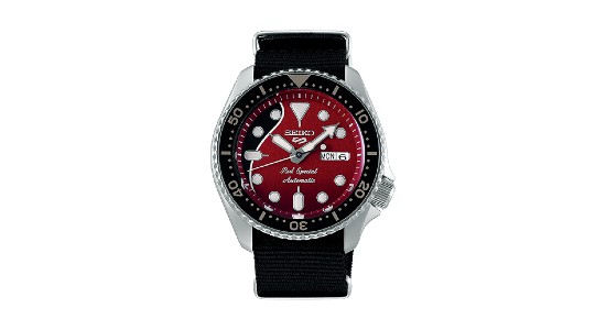 a silver watch by Seiko with a split black and red watch face and a black strap