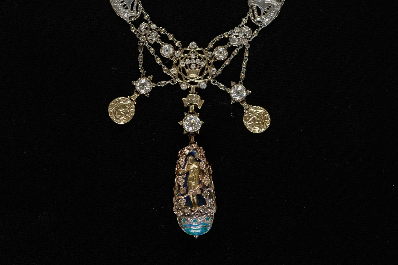 A close-up of an ornate and intricate necklace, studded with diamonds and elegant pendants.