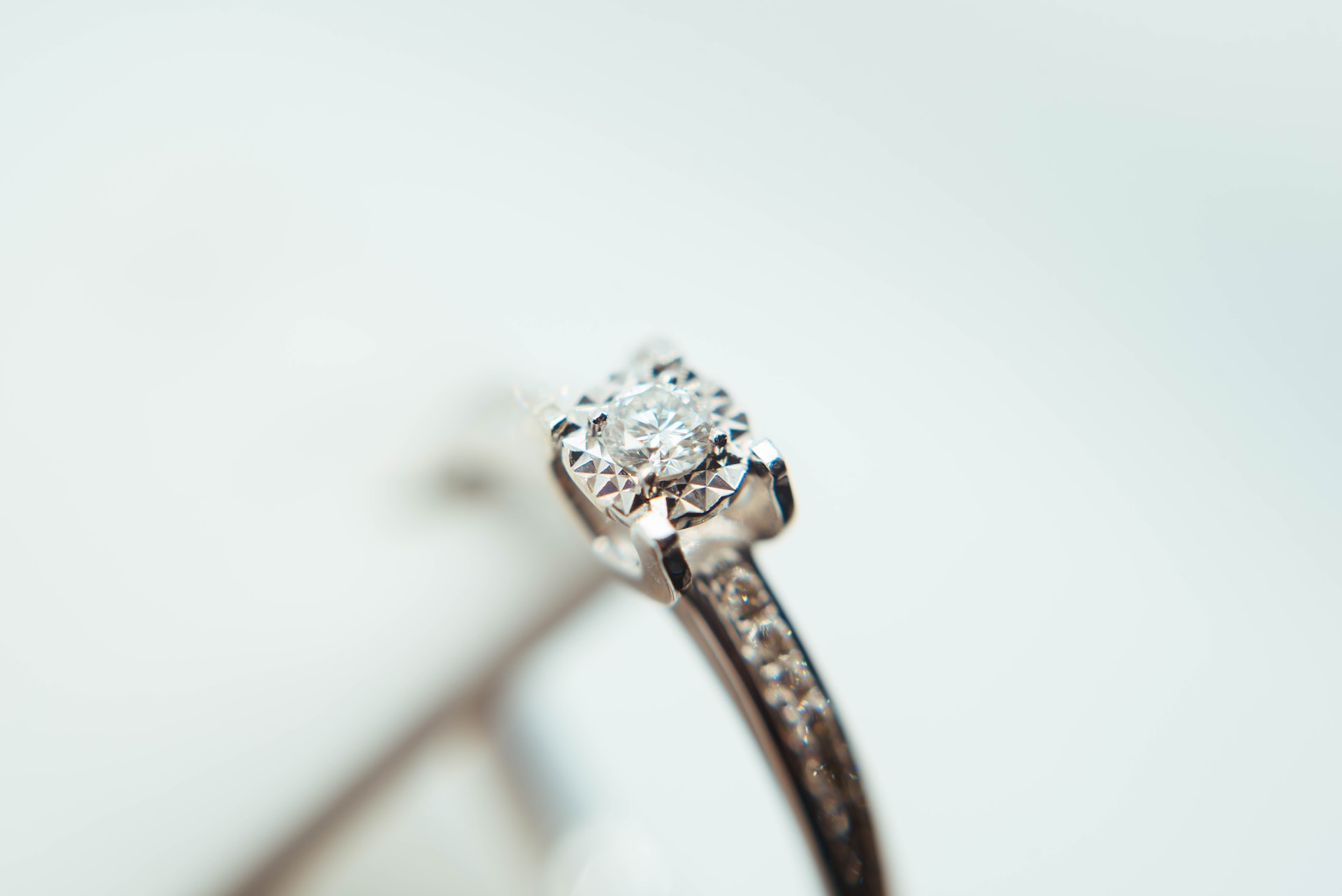 a round cut, chanel side stone engagement ring
