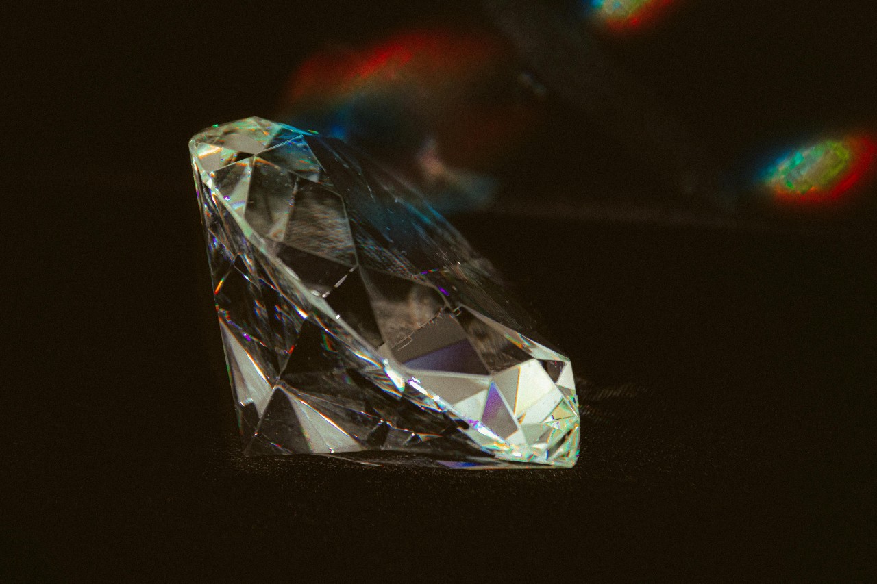 a round cut diamond close up against a black background