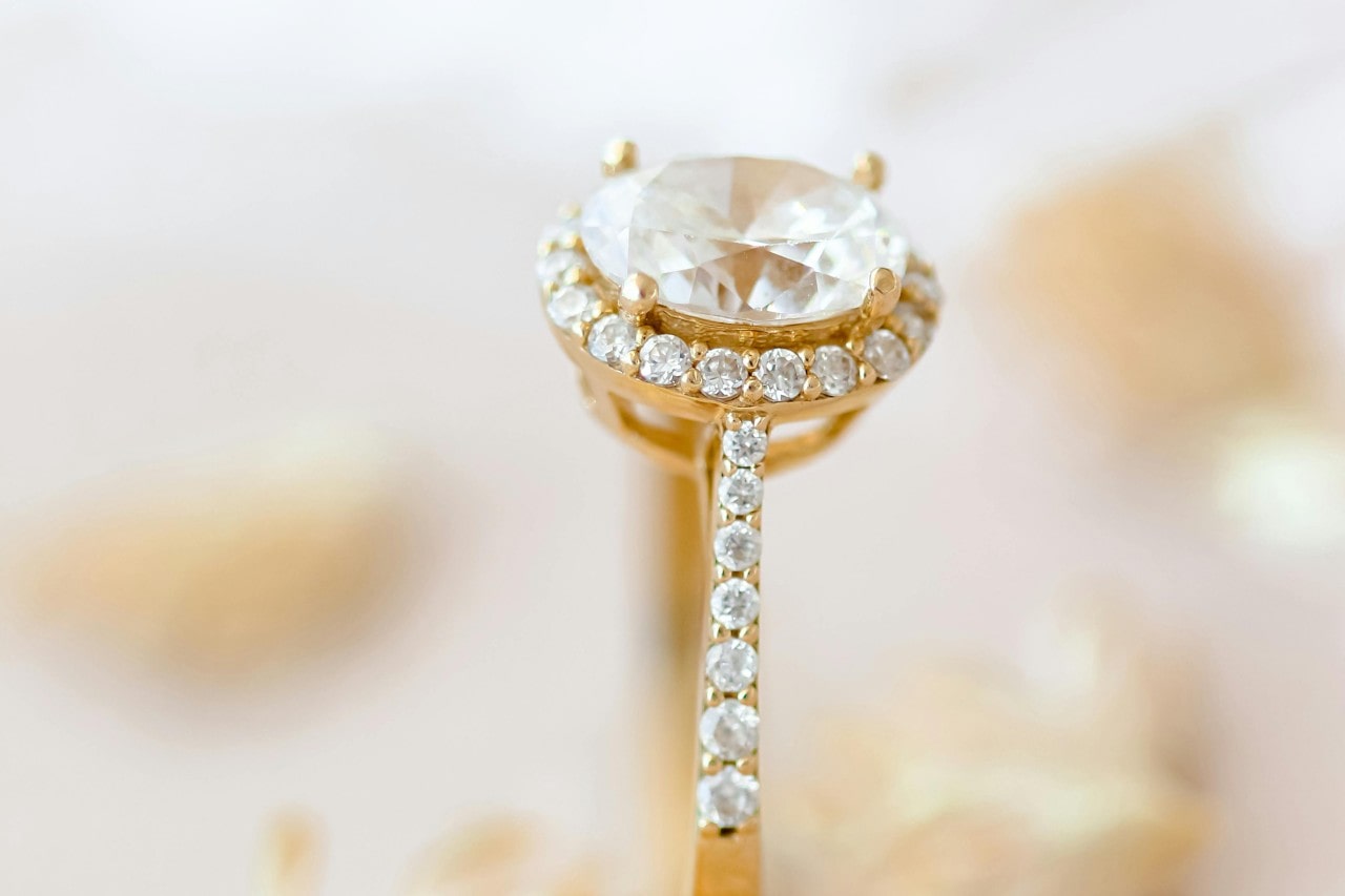 an oval cut engagement ring with a halo and side stones