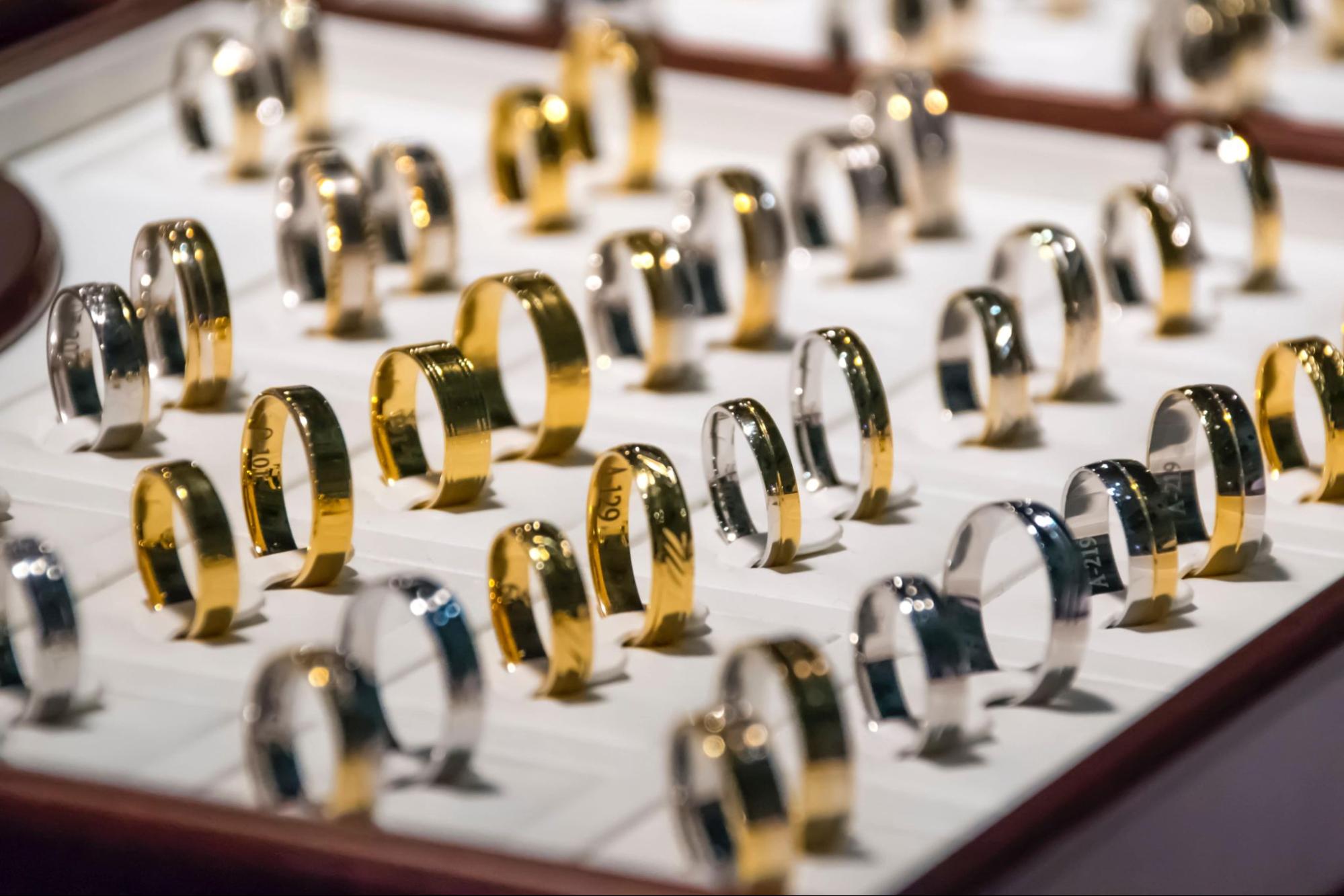 A close-up of a wide selection of gold men’s wedding rings.